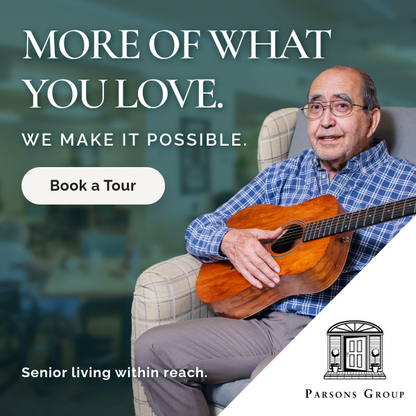 Senior living ad: elderly man with a guitar sits in a cozy room; overlay reads 'MORE OF WHAT YOU LOVE. WE MAKE IT POSSIBLE.' with a 'Book a Tour' button and Parsons Group logo.