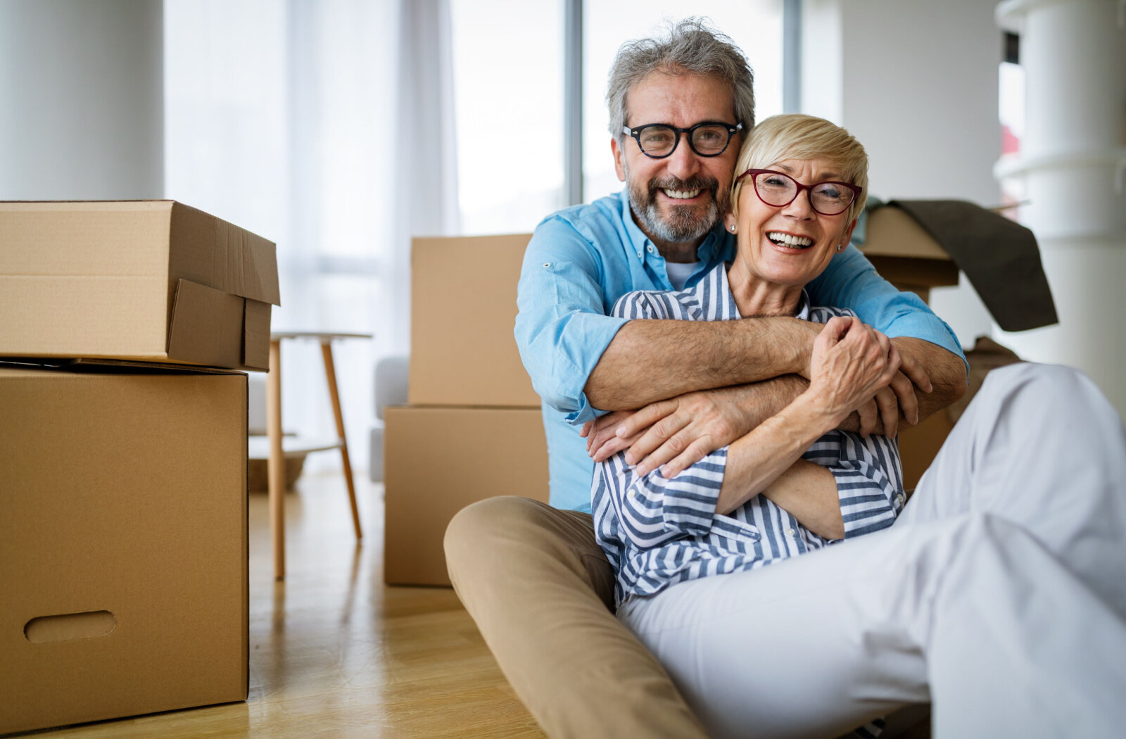 Portrait of the happy senior couple enjoying their time while packing before they move into the new house.