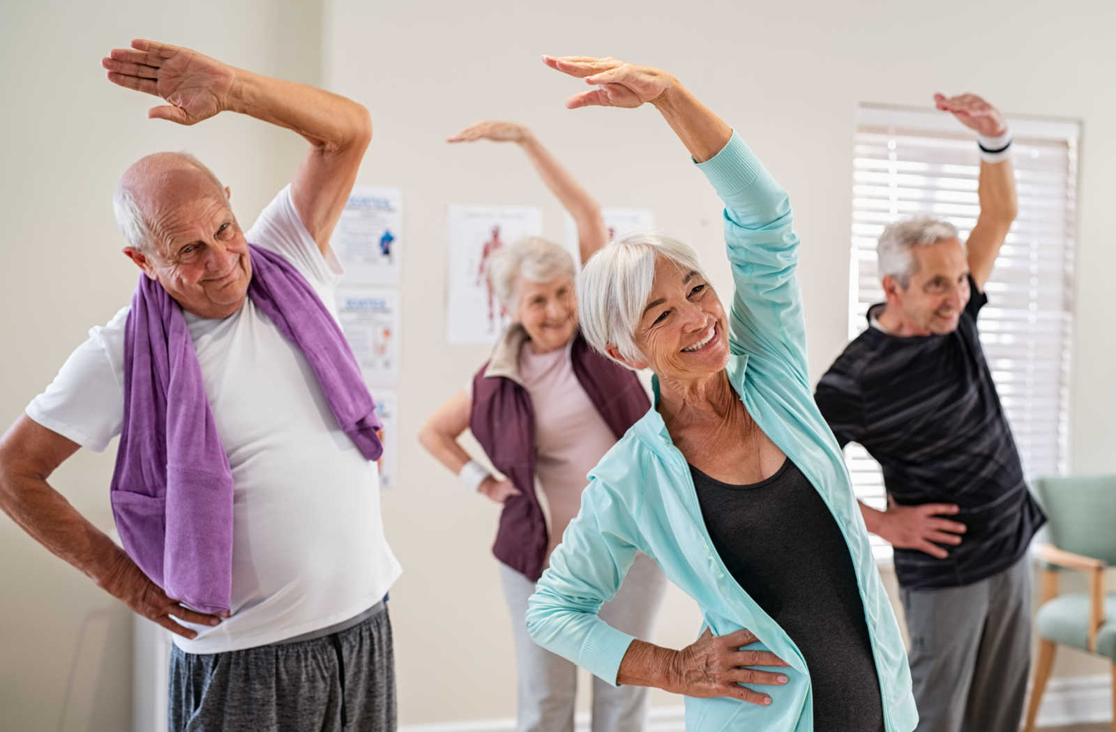 A group of seniors exercising together in a senior living community.