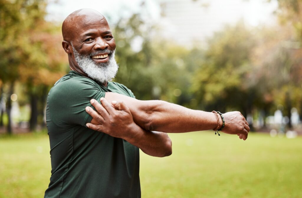 A senior stretching & warming up before they go on a run to avoid injuries.