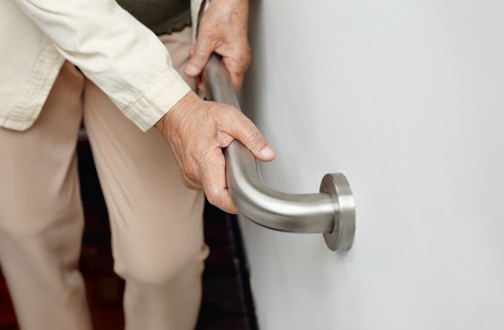 A senior using a grab bar to help with balance & safety.